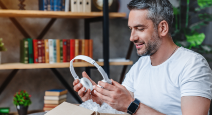 Man holding a pair of headphones