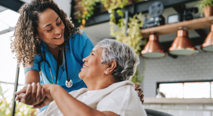 Caregiver holding woman's hand
