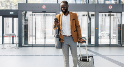 Man at the airport looking at his phone